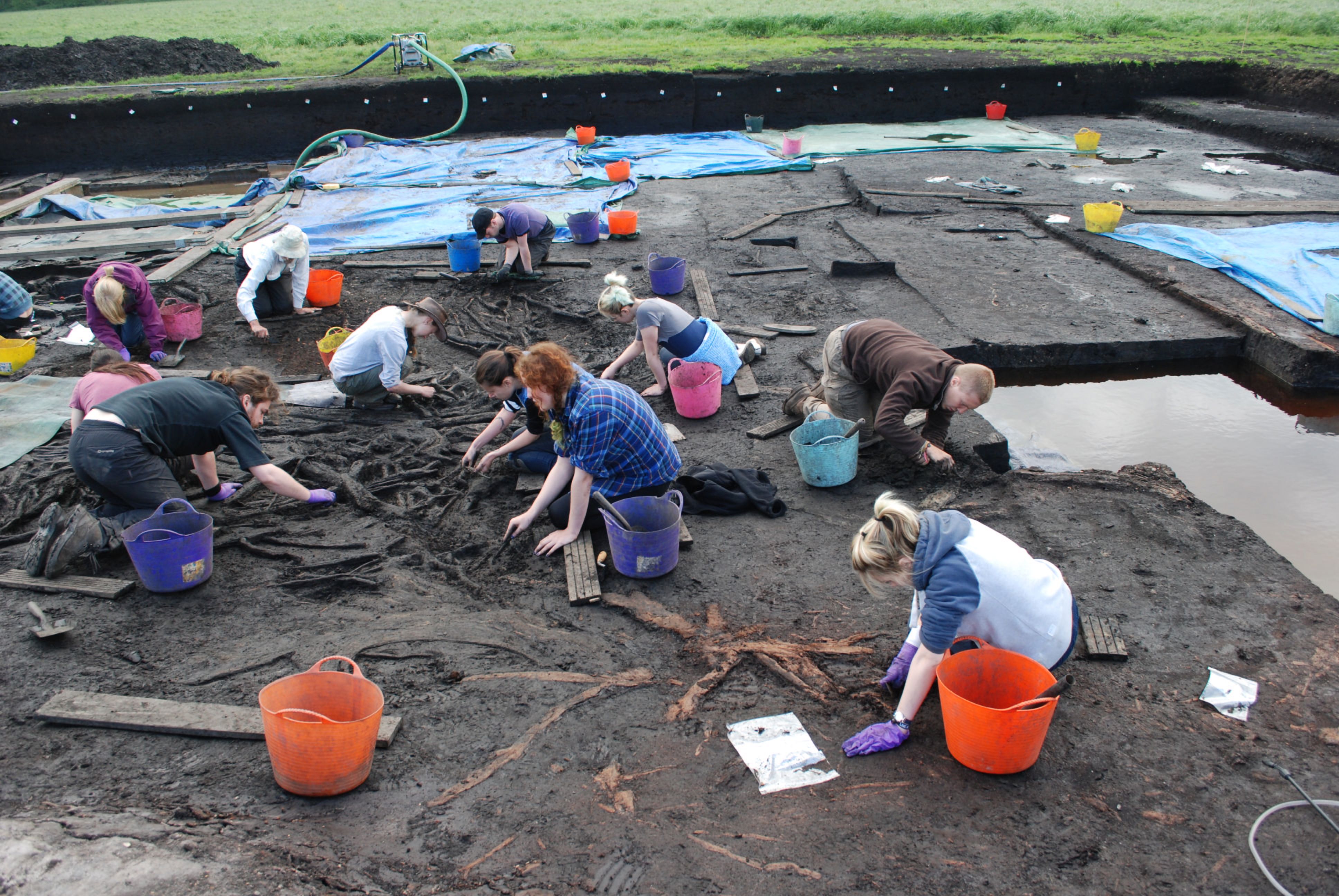 A picture of staff and students excavating wood uncovered at Star Carr